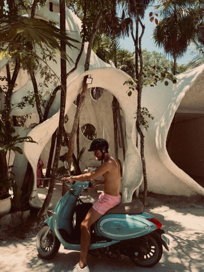 Rider on a turquoise scooter outside Azulik Tulum