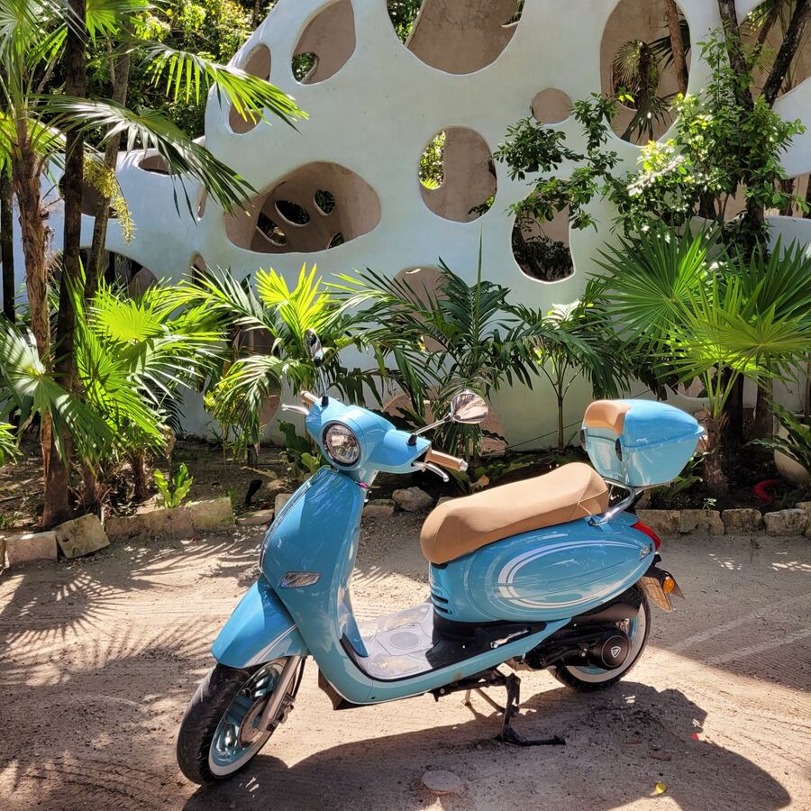 Blue scooter parked in Tulum